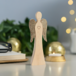 Wendeengel mit Herz aus Holz vor goldener Weihnachtsdeko